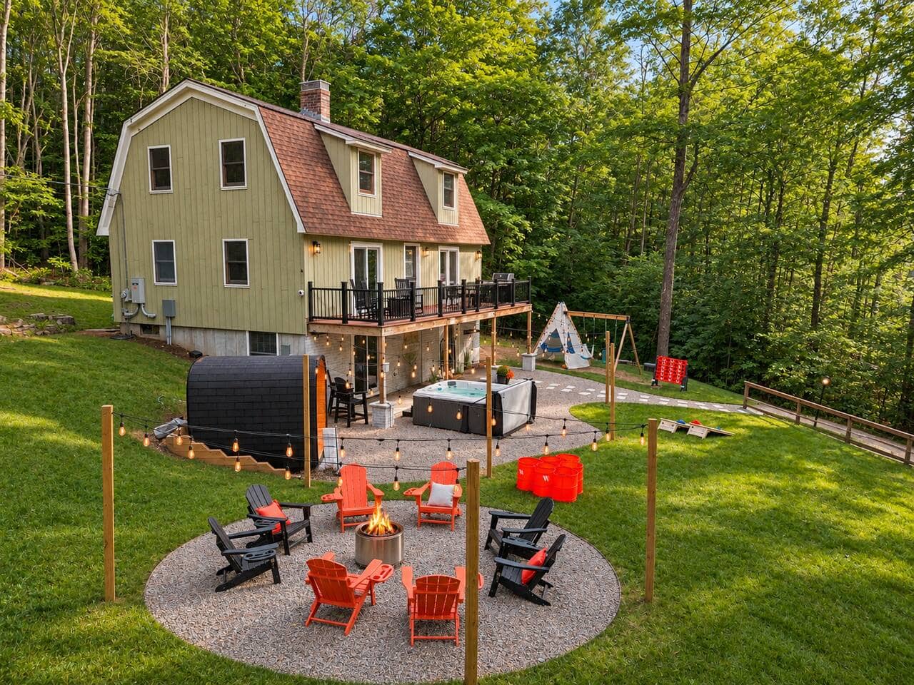 Exterior of Peak & Pine Retreat with stone patio, fire pit and yard games